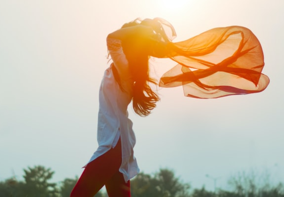 Woman walking outside with flowing cloth